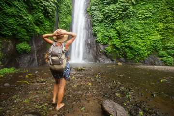 Woman near Munduk waterfal on Bali, Indonesia