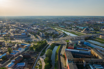 Naklejka premium Aerial view of old European city center or downtown, modern and historic buildings, factories and car traffic in sunny summer day