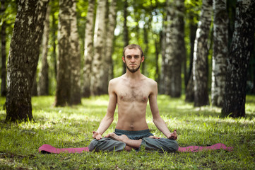 Yoga man meditating at sunset. Male model of meditation in serene harmony