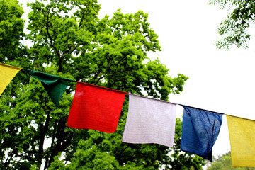 Colorful prayer flags (lungta/darcho) of Buddhist philosophy with mantra and butterfly in the wind...