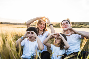 Portrait of a happy and fun family in the countryside. Concept of united family smiling