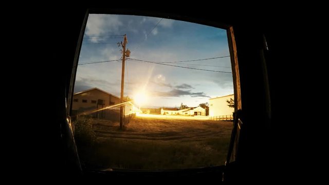 TIME LAPSE - Looking through a window frame at a storm coming forward in a small town call Empress Alberta Canada.