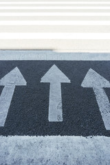  Three white arrows on asphalt, direction up. Index sign.