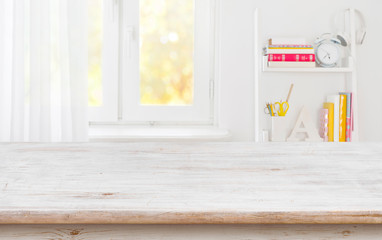 Rustic wood table for product display over blurred schooler room