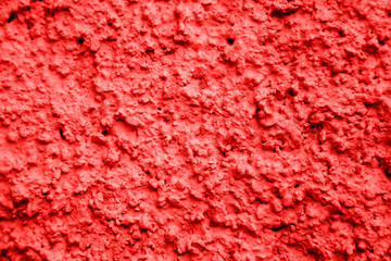 An old ragged plaster red wall texture, cracked and old  for background,rough cement wall