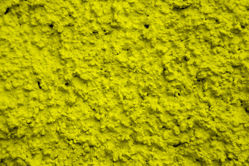 An old ragged plaster yellow wall texture, cracked and old  for background,rough cement wall