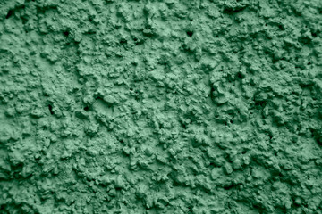 Fototapeta na wymiar An old ragged green plaster wall texture, cracked and old for background,rough cement wall