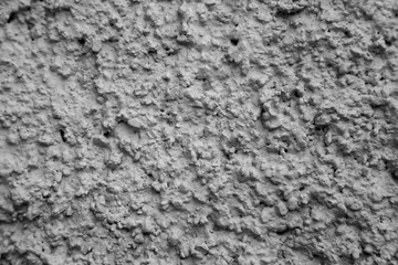 An old ragged grey plaster wall texture, cracked and old  for background,rough cement wall