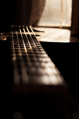 Acoustic Guitar In Music Studio Close up. Shined By The Sun At The Golden Hour