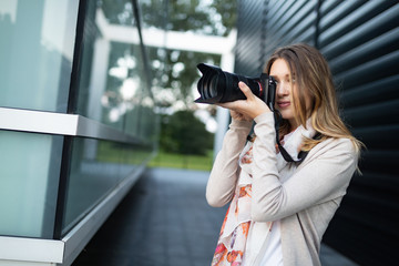 Woman is a professional photographer with dslr camera