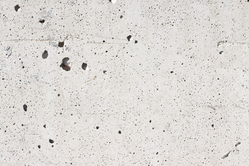 New concrete wall background with holes left by the evaporation of the mixing water