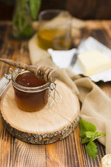 Glass jar full of honey with honey spoon
