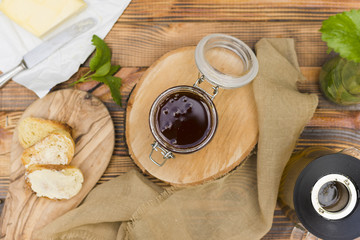 Glass jar full of honey with honey spoon
