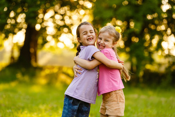 sister girls playing on the green park outdoor