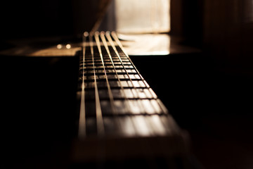Acoustic Guitar In Music Studio Close up. Shined By The Sun At The Golden Hour