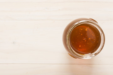 Top view glass jar full of honey