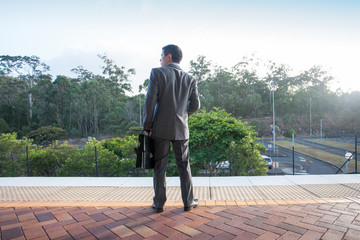 Man with office dress waiting at station