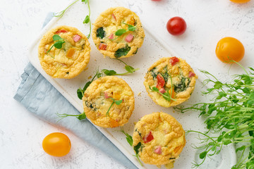 omelet with tomatoes and bacon, baked eggs with spinach and broccoli, top view, keto, ketogenic diet