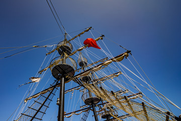 Low viewing angle of three masts of a sailing vessel. 