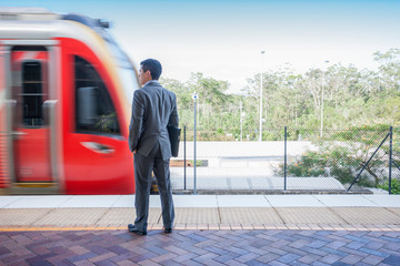 Man with black dress going to get in train