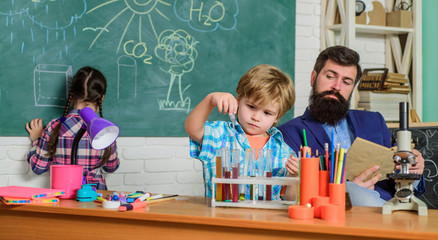 Science and education. chemistry lab. back to school. happy children & teacher. children making science experiments. Education. doing experiments with liquids in chemistry lab. Hard choice