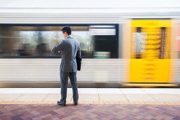 Fototapeta na wymiar Smart man holding files near train
