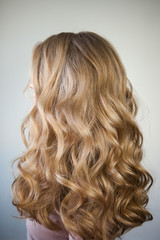 Naklejka premium blond with perfect curls, long hair with curls,