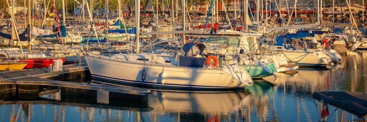 Colorful sailboats at sunset in the old harbor of La Rochelle, France