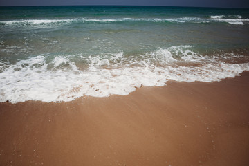 Mediterranean beach with turquoise water in sunny weather