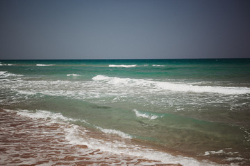 Mediterranean beach with turquoise water in sunny weather