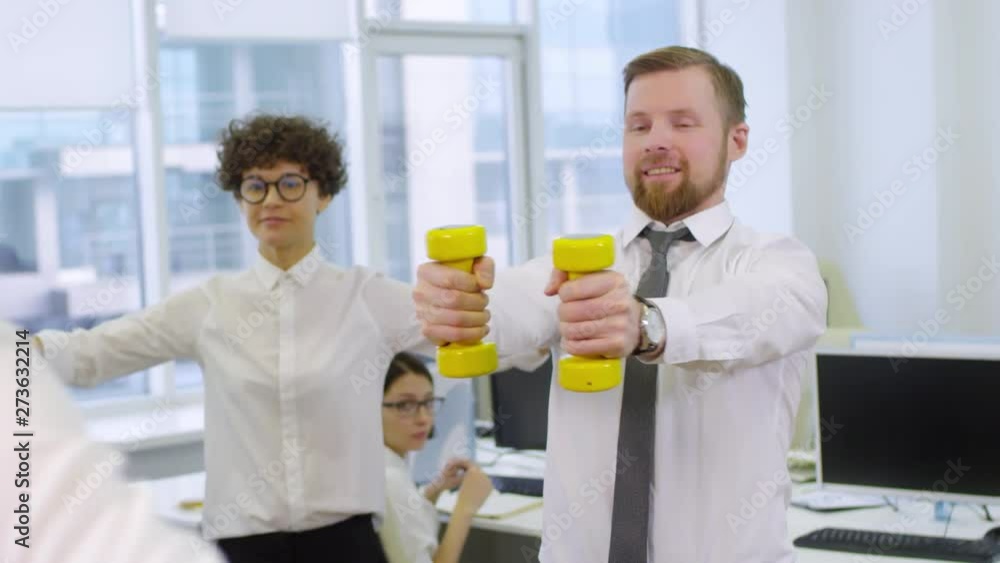 Poster medium shot of caucasian businessman and businesswoman standing and exercising with dumbbells, repea