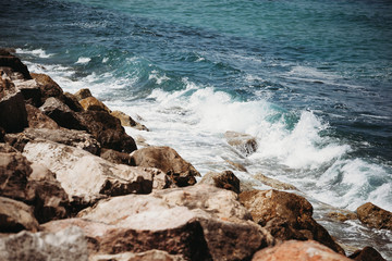 the waves of the sea beat against the stones