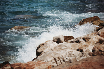 the waves of the sea beat against the stones