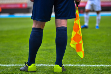 Assistant referee or Lineman of football or soccer holding flag