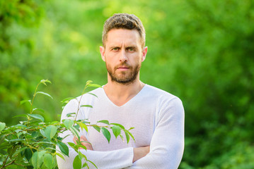 Naklejka na ściany i meble Feel power of nature. Man handsome bearded hipster stand confidently nature background. Skin care. Nature peaceful environment. Natural beauty remedies. Keep it healthy way. Nature relax spa resort