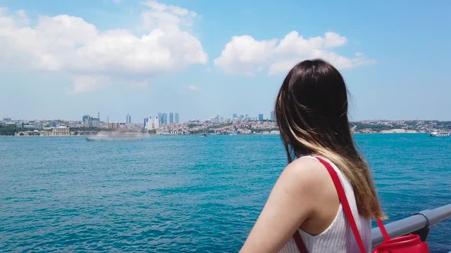 beautiful girl stands in front of Bosphorus,a popular destination in Istanbul,Turkey