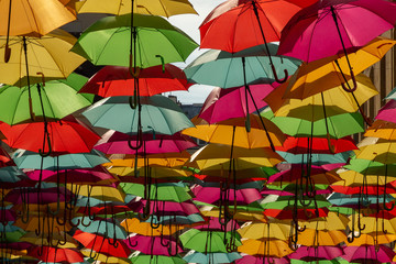 Fototapeta na wymiar colorful umbrellas decorating the ceiling of a passage