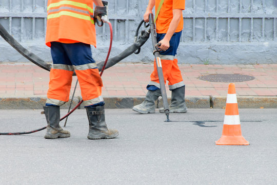 Repair of the road. Working repairing asphalt pavement
