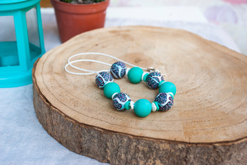 Boho rustic still life with jewelry.  Polymer clay modern necklace.