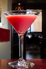 Red mango juice glass with ice cubes