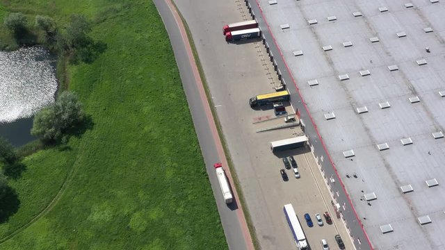 Aerial Shot of Truck with Attached Semi Trailer Leaving Warehouse complex -