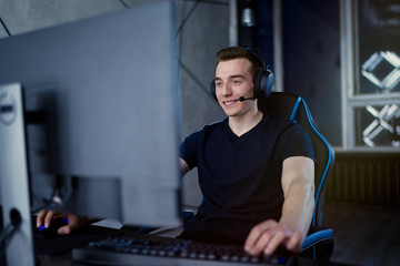 Professional gamer playing online video game at night time © D'Action Images