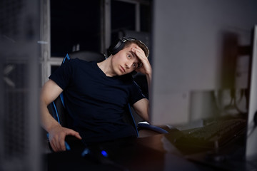 Young upset gamer playing online video games on computer and feel depressed 