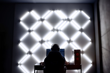 Professional gamer in his expensive studio young man having live stream playing online video game....
