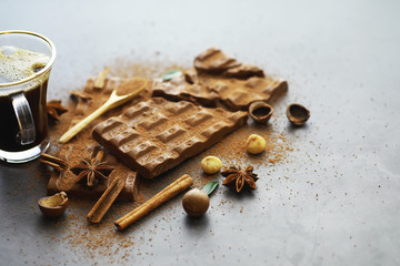 A bar of milk chocolate on the table. Chocolate with nuts and cinnamon.