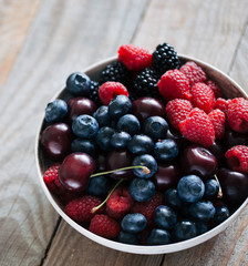 berries in a bowl on old wooden board