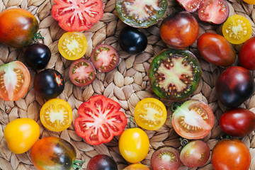 wicker kitchen mat and cut organic tomatoes