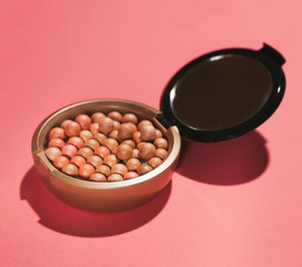 makeup powder in balls shape on pink paper