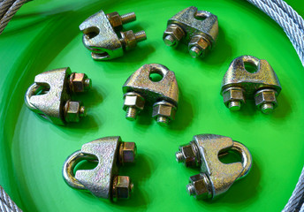 Clamps for cables and a steel cable placed on a stand