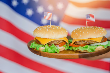American hamburger or cheeseburger with america flag for USA 4th of July independence day food background concept